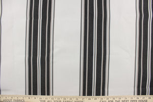 This  fabric features a stripe design in varying shades of gray from pale gray to dark almost black gray.