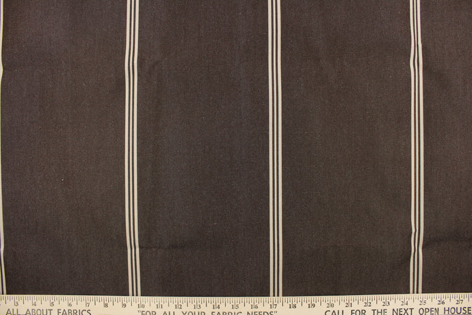 This fabric features a stripe design in rich brown and light beige. 