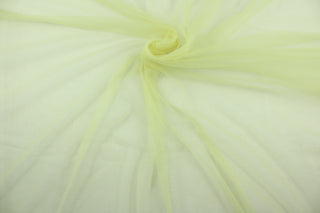 A sheer, light weight, and semi firm tricot in light green yellow .
