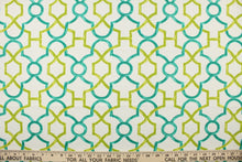 Load image into Gallery viewer, This printed cotton twill fabric features a geometric design in green and teal on a white background.  It is perfect for window treatments, decorative pillows, handbags, light duty upholstery applications.  This fabric has a soft workable feel yet is stable and durable with 50,000 double rubs.  
