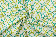 Load image into Gallery viewer, This printed cotton twill fabric features a geometric design in teal and green on a white background.  It is perfect for window treatments, decorative pillows, handbags, light duty upholstery applications.  This fabric has a soft workable feel yet is stable and durable with 50,000 double rubs.  
