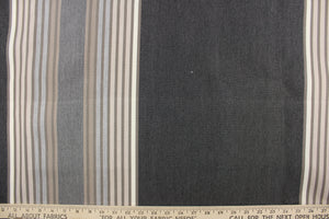 This fabric features a stripe design in gray, taupe, pale beige, dark gray and brown.