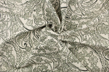 Load image into Gallery viewer, This fabric features a paisley design in  green gray tone set against a natural white . 
