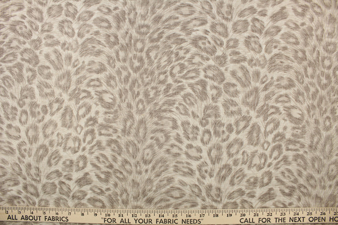  This fabric features a cheetah design in taupe and gray tones . 