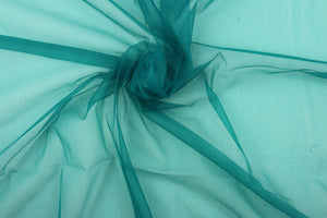 A sheer, light weight, and semi firm tricot in rich teal.