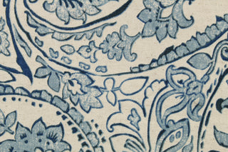  This fabric features a paisley design in blue tones set against a natural white .