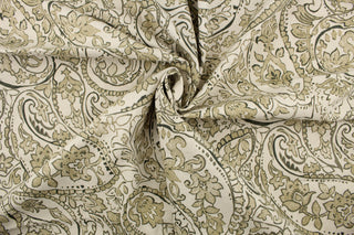 This fabric features a paisley design in moss green, beige and off white .