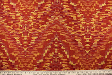 Load image into Gallery viewer, This fabric features varying shades of red, yellow and orange.   It is durable and hard wearing and would be great for multi-purpose upholstery, bedding, cornice boards, accent pillows and drapery.  
