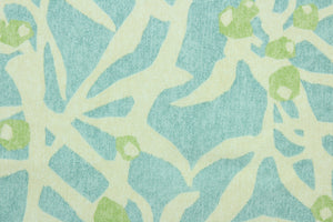  This fabric features a branch design in light blue and light green against a off white. 