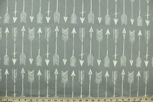 This fabric features arrow design in white set against a gray background.