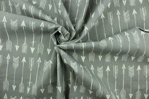  This fabric features arrow design in white set against a gray background.