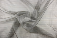 Load image into Gallery viewer, This sheer fabric features a stripe design in silver and black with blue undertones . 
