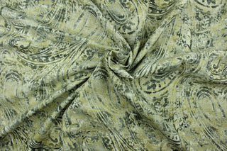 This fabric features a paisley design in gold, and varying shades of gray. 