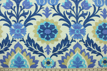 Load image into Gallery viewer,  This outdoor fabric features a floral design in tan, turquoise, blue, and hints of purple set against a pale beige background.
