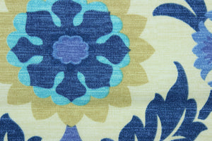  This outdoor fabric features a floral design in tan, turquoise, blue, and hints of purple set against a pale beige background.