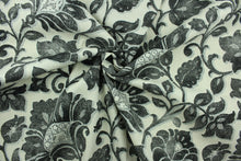 Load image into Gallery viewer, This fabric features a floral design in black, and gray against a pale beige. 
