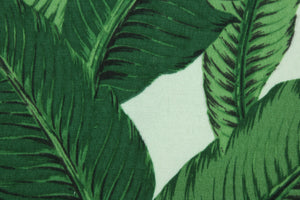 This fabric features palm tree leave design in green, black, golden tan and white.
