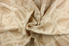 Load image into Gallery viewer, This sheer fabric features a circular design in a beige and nude .
