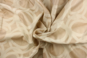 This sheer fabric features a circular design in a beige and nude .
