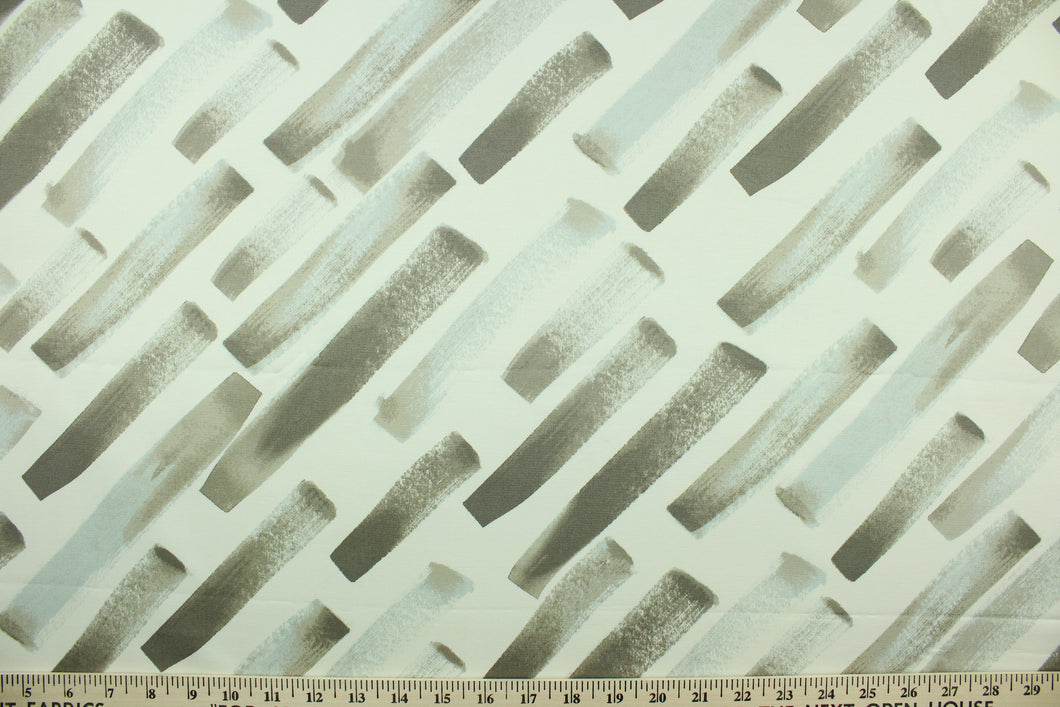 his fabric features a diagonal  broken stripe design in gray, taupe, and white. 