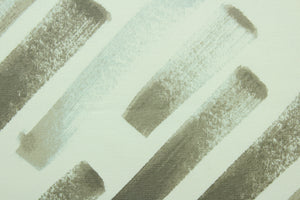 his fabric features a diagonal  broken stripe design in gray, taupe, and white. 