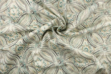 Load image into Gallery viewer, This fabric features a decorative overlapping circle design in shades of gray, turquoise, and beige set against a dull white . 
