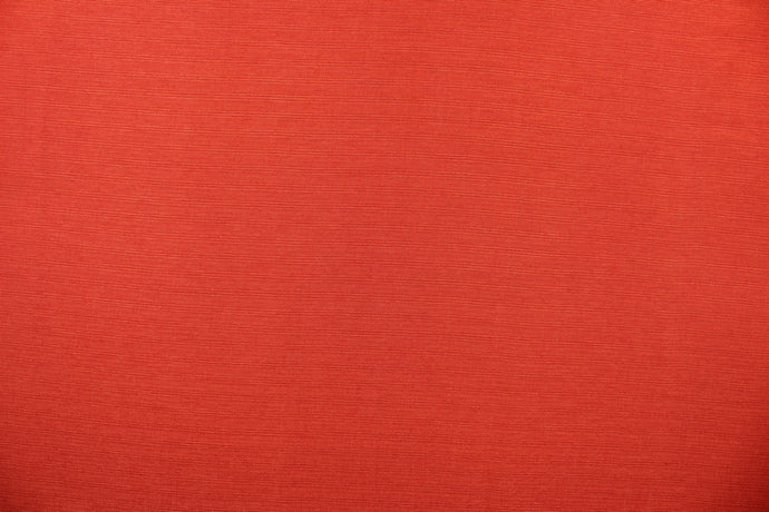 A mock linen in bright coral red with a slight shine. 