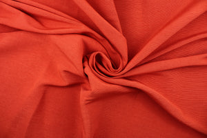 A mock linen in bright coral red with a slight shine. 