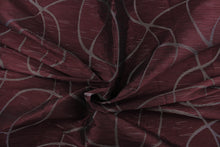 Load image into Gallery viewer,  This sheer fabric features a swirl line design in silver against a dark maroon . 
