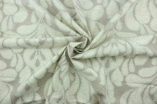 This fabric features a beautiful demask design in silver, and white against a beige background.