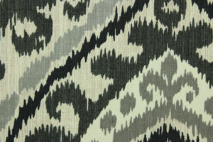 This fabric features a geometric design in varying shades of gray set against a off white background. 