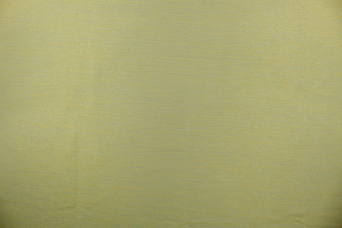 A mock linen in lime green with hints of blue and gold.