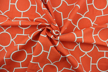 Load image into Gallery viewer,  This fabric features a geometric design in white outlined in gray set against a bright orange background. 
