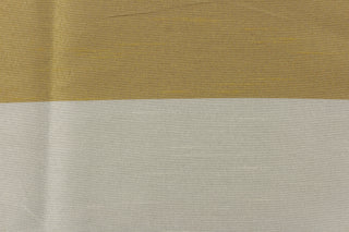 This sheer fabric features a wide stripe design in a gray, gold and silver . 