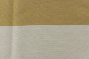 This sheer fabric features a wide stripe design in a gray, gold and silver . 