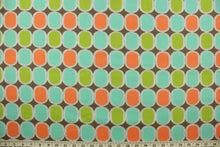Load image into Gallery viewer, This fabric features a geometric design in bright orange, lime green, and turquoise outlined in white and set against a brown background. 
