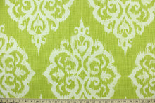 Load image into Gallery viewer, This fabric features an ikat damask design in  lime green and white
