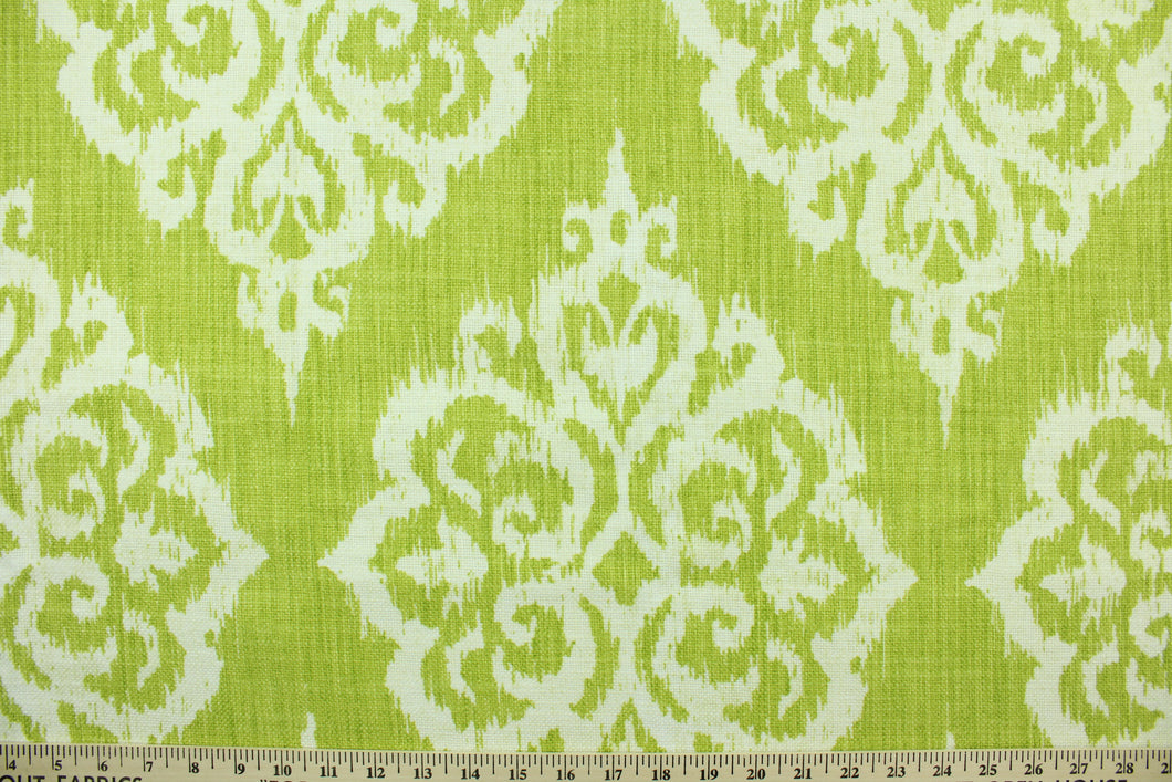 This fabric features an ikat damask design in  lime green and white