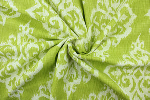 This fabric features an ikat damask design in  lime green and white