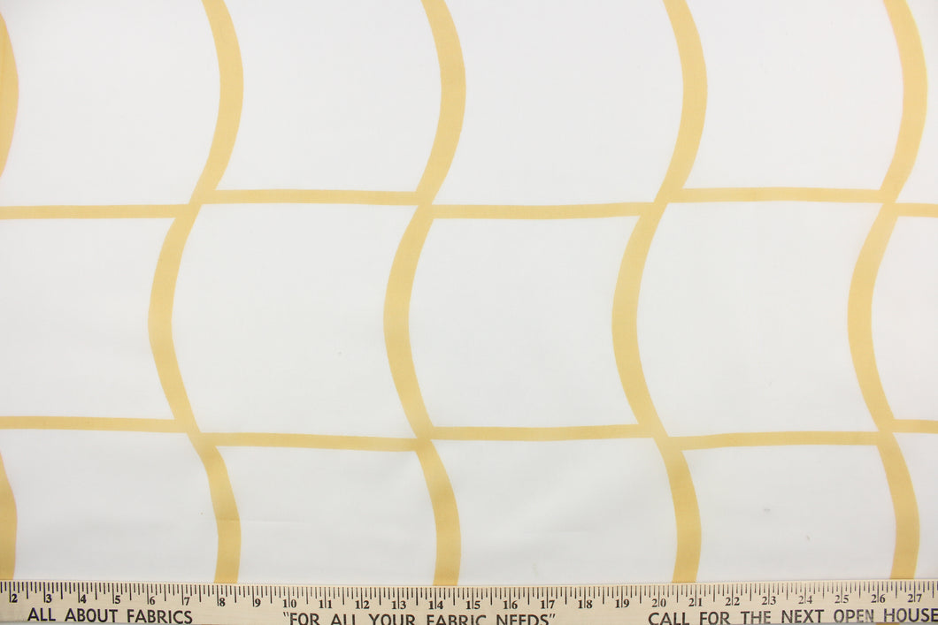  This sheer fabric features a plaid design in a golden yellow against white.