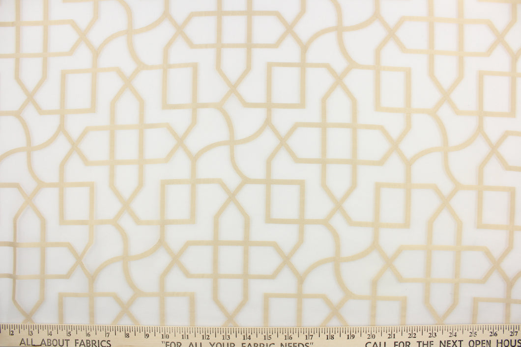 This sheer fabric features a geometric design in gold against white.