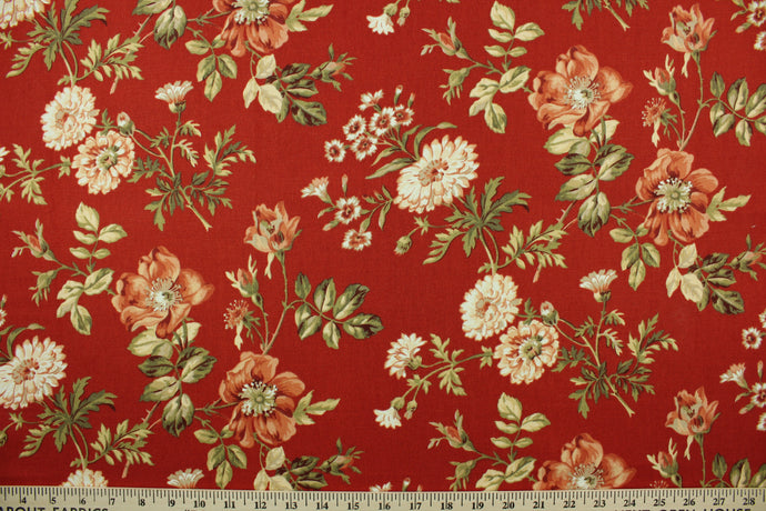 This fabric features a floral design in green, beige, coral, and white set against a red background. 