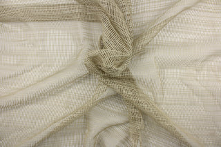 This sheer fabric features a design in beige  .