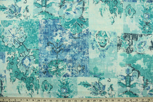 This fabric features a abstract design in blue, turquoise, gray, and teal.