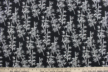 Load image into Gallery viewer, This fabric features white bamboo plants in white on a black background. It has a nice soft hand and would be great for quilting, crafting and home decor.  
