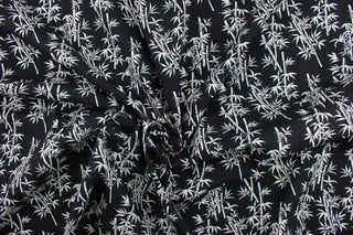 This fabric features white bamboo plants in white on a black background. It has a nice soft hand and would be great for quilting, crafting and home decor.  