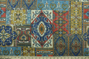 This fabric features a mix design in royal blue, orange, pale beige, golden tan, black, blue, and washout red. 