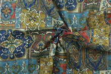 Load image into Gallery viewer, This fabric features a mix design in royal blue, orange, pale beige, golden tan, black, blue, and washout red. 
