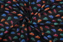 Load image into Gallery viewer, This fabric features multi colored cars in red, blue, green, purple and orange on a black background.  It has a nice soft hand and would be great for quilting, crafting and home decor.  
