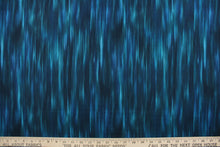 Load image into Gallery viewer, This fabric in shades of blue and teal with accents of black blend together to create a beautiful color palette.  It has a nice soft hand and would be great for  quilting, crafting and home decor.  
